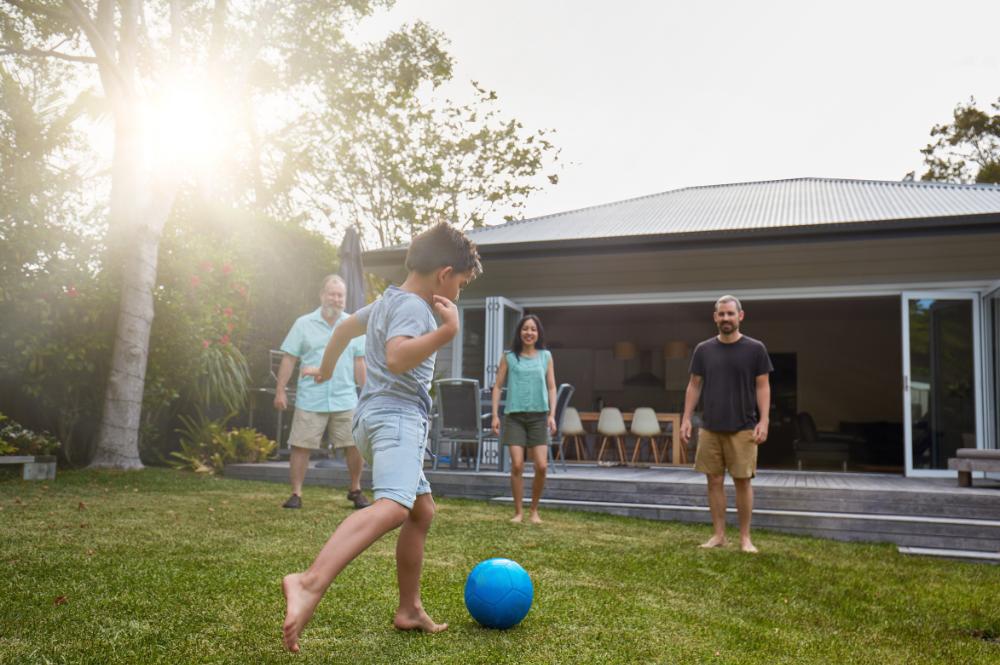 Image of Australian family playing in backyard.